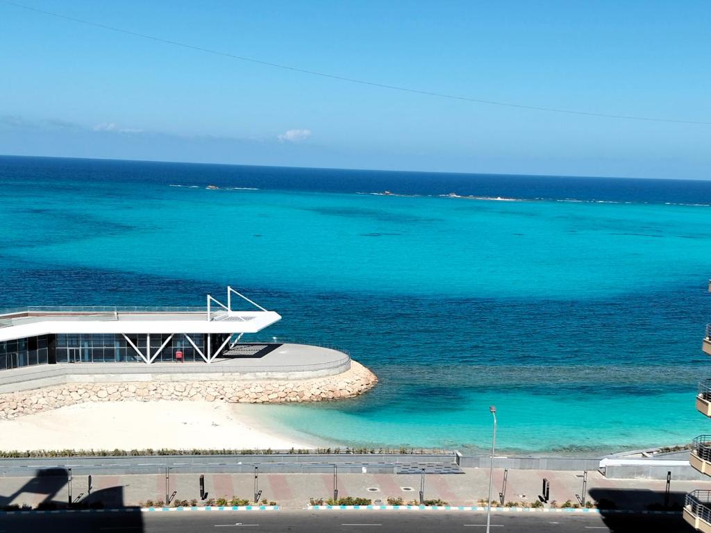 a building on the beach next to the ocean at Luxury units for rent on the sea in Marsa Matruh