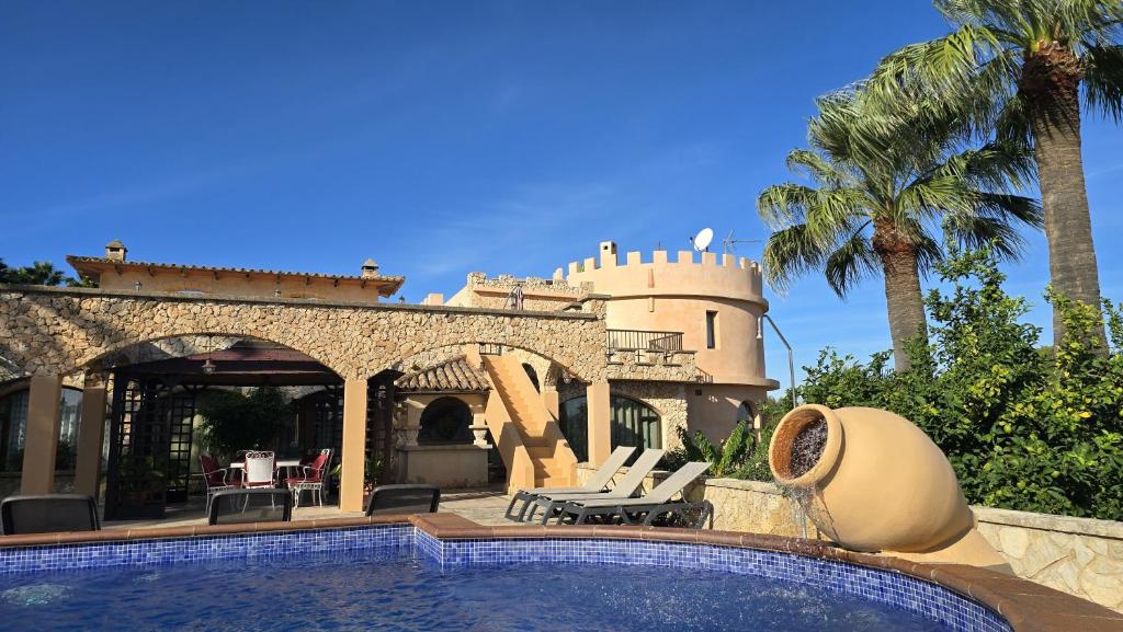 a villa with a swimming pool and a house at Castell Villa Bohío Mallorca in Urbanicacion ses palmeres