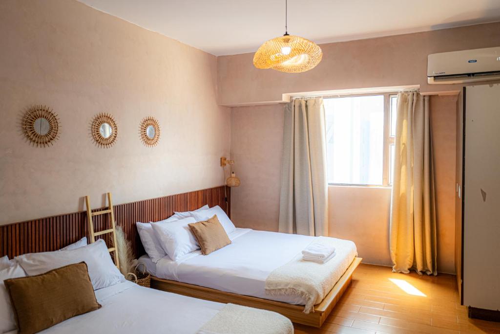a bedroom with two beds and a window at Destiny Hotel - 1605 in Sampong