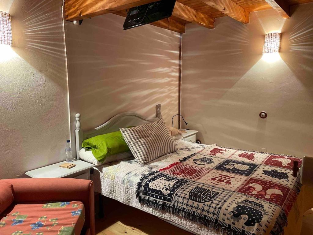 a bedroom with a bed with a quilt on it at The Walnut tree in San Miguel de Luena