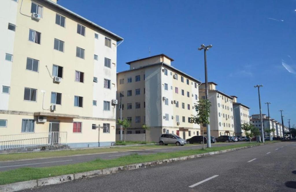 a row of tall buildings on a street at Condomínio Citta COP30 in Marituba