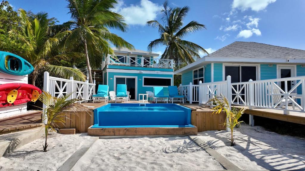 a house on the beach with a swimming pool at The Calm Water Villas in Georgetown
