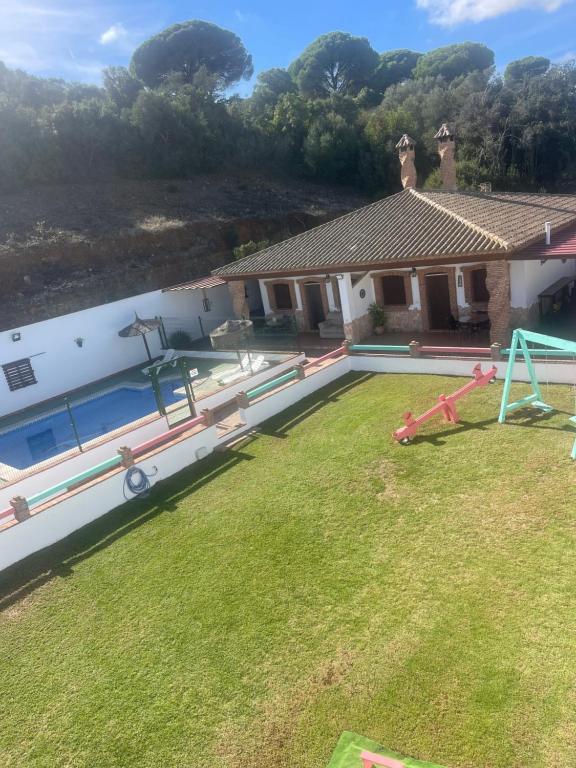 een huis met een tuin met een zwembad bij ESPECTACULAR Casa Rural NURIA máx 14 personas in Barbate