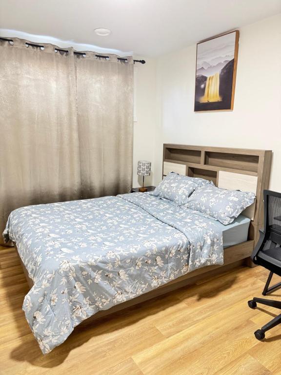 a bedroom with a bed and a chair at Elegant Modern Suite with Comfort & Privacy in Regina