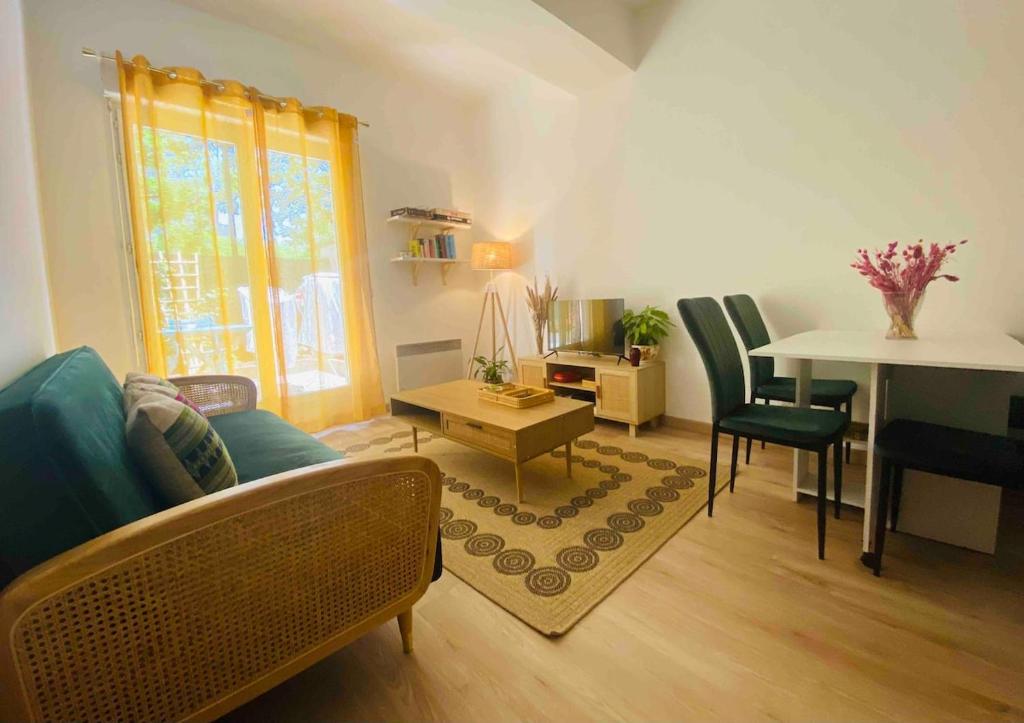 a living room with a couch and a table at Zen and chill F2 appartment and garden near Paris in Chelles