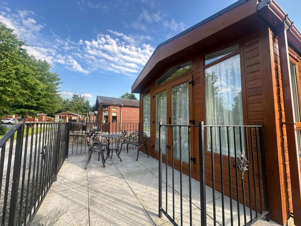 a house with a deck with a patio at Glen-coo in Auchterarder