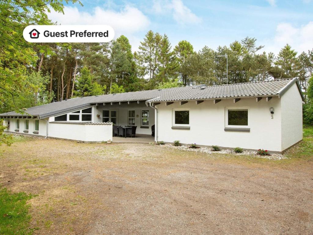 a house with a driveway in front of it at 14 person holiday home in Sæby in Sæby