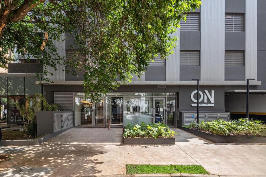 a building with a sign on the front of it at On Jurupis in Sao Paulo
