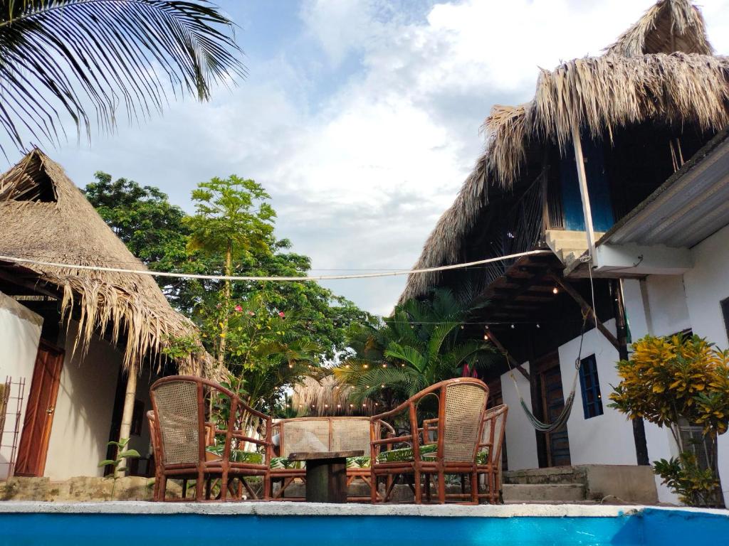 a resort with chairs and a swimming pool at Casa sol palomino in Palomino