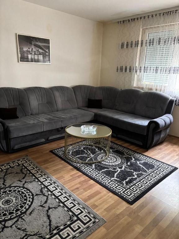a living room with a couch and a table at Apartman Zaki luxury in Borča