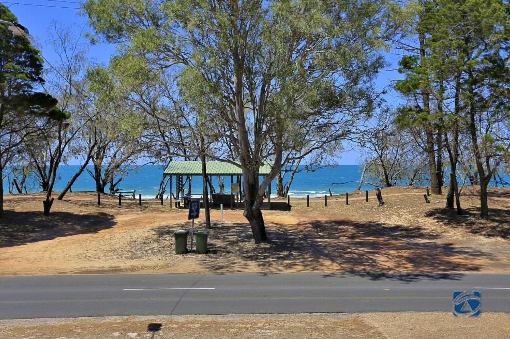 a park with a gazebo and trees on the beach at 25 The Esplanade in Woodgate