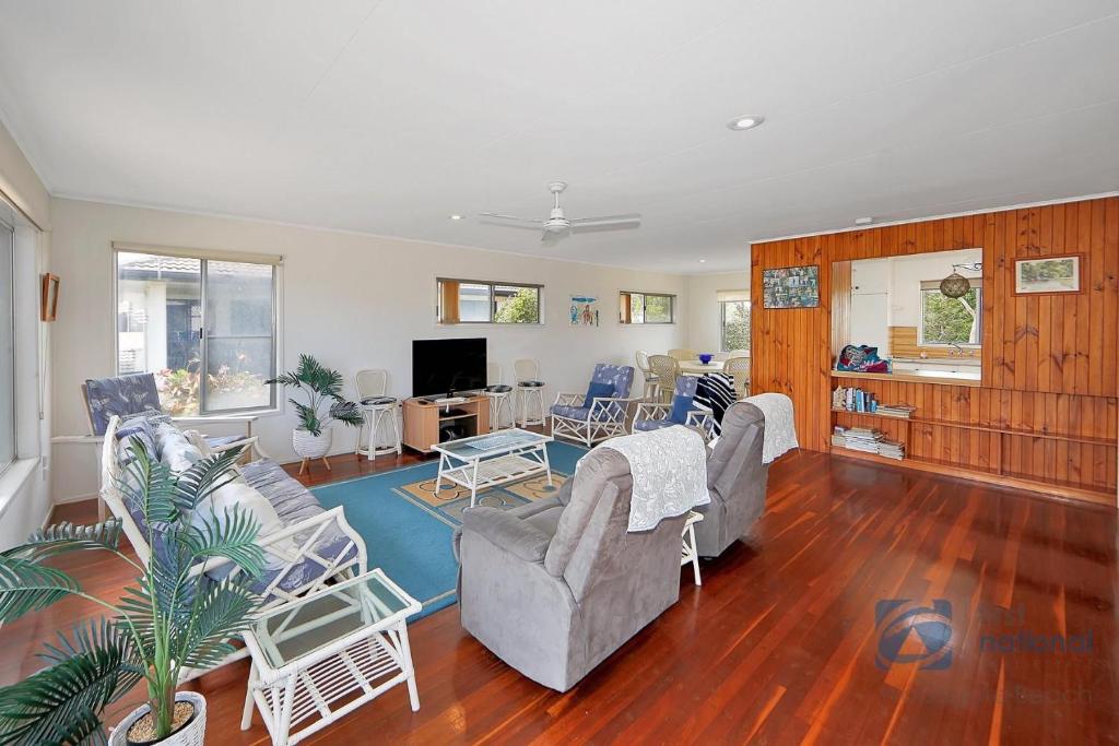 a living room with two couches and a table at 103 The Esplanade in Woodgate