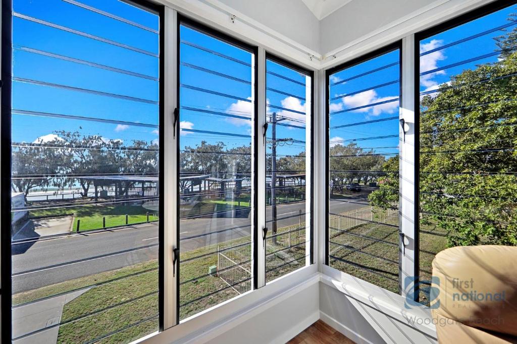 a room with windows with a view of a street at 158 The Esplanade in Woodgate
