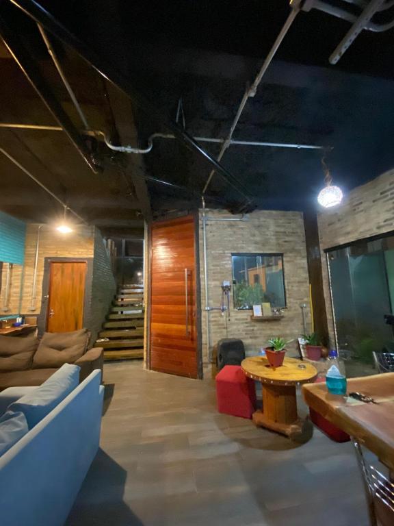 a living room with a couch and a table at Hostel Fabulosa Casa de tijolinhos in Arapiraca