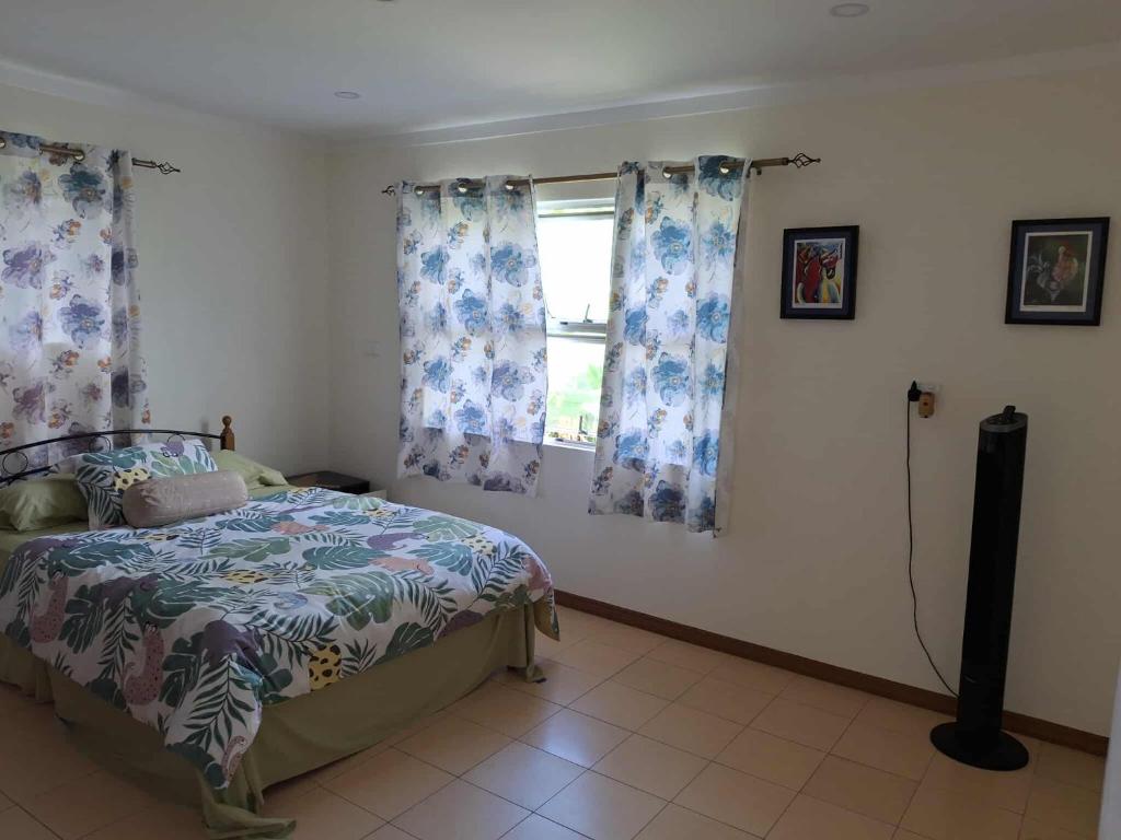 a bedroom with a bed and a window at Sekoula Home in Suva