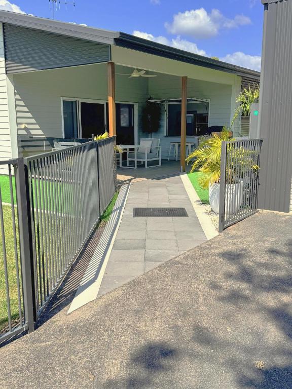 a house with a gate and a patio at 7 Pine Court in Woodgate