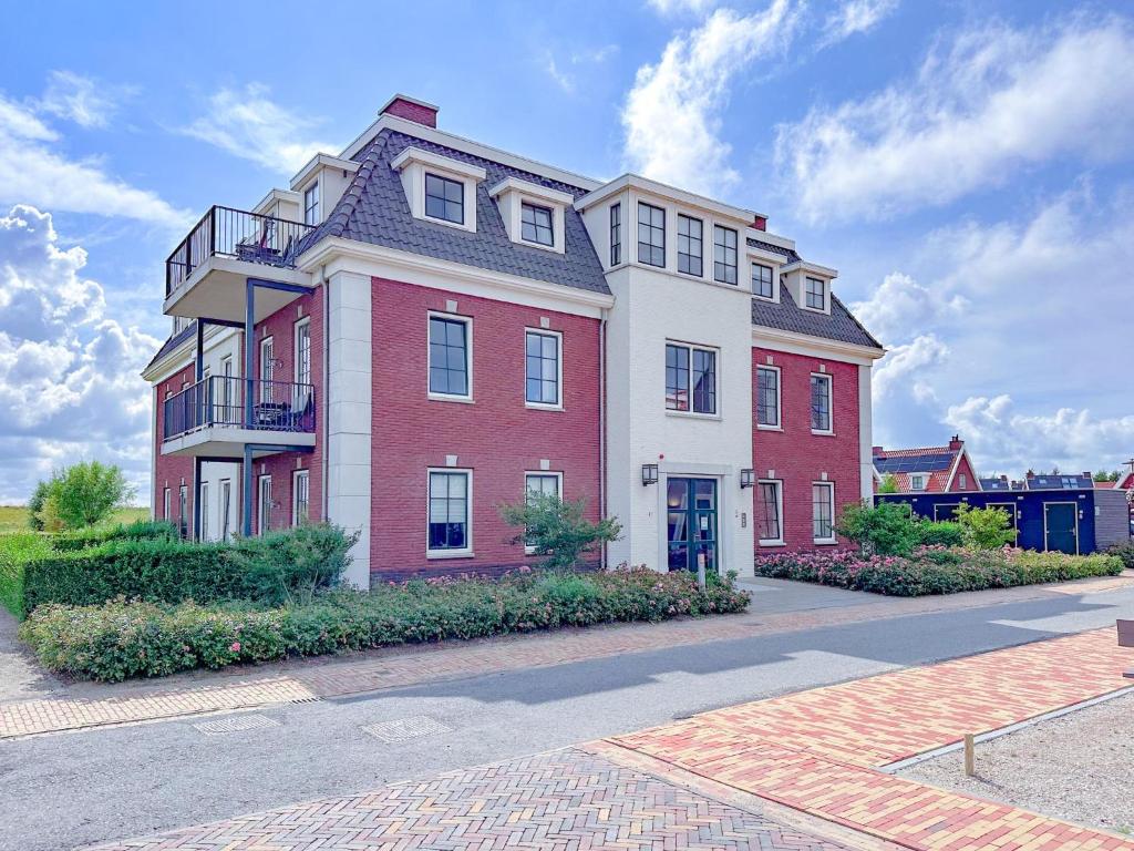 a large red and white building on a street at SeaLuxe Suite 27D in Colijnsplaat