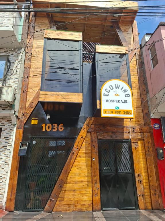 a building with a sign on the front of it at Casona Eco Wing in Iquique