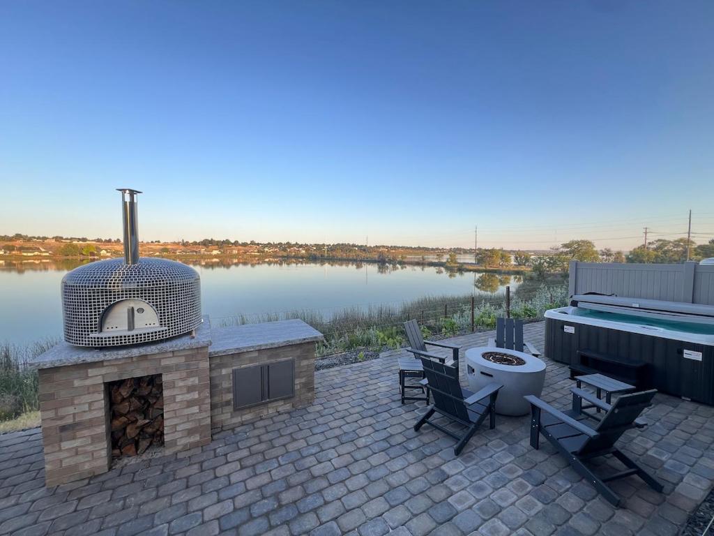 a patio with a grill and a toilet and a tub at Moses Lake Vineyard Retreat-Waterfront Escapism in Moses Lake