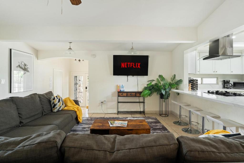 a living room with a couch and a kitchen at Near Safari & Beach - Backyard Games - AC - Pet OK in Escondido