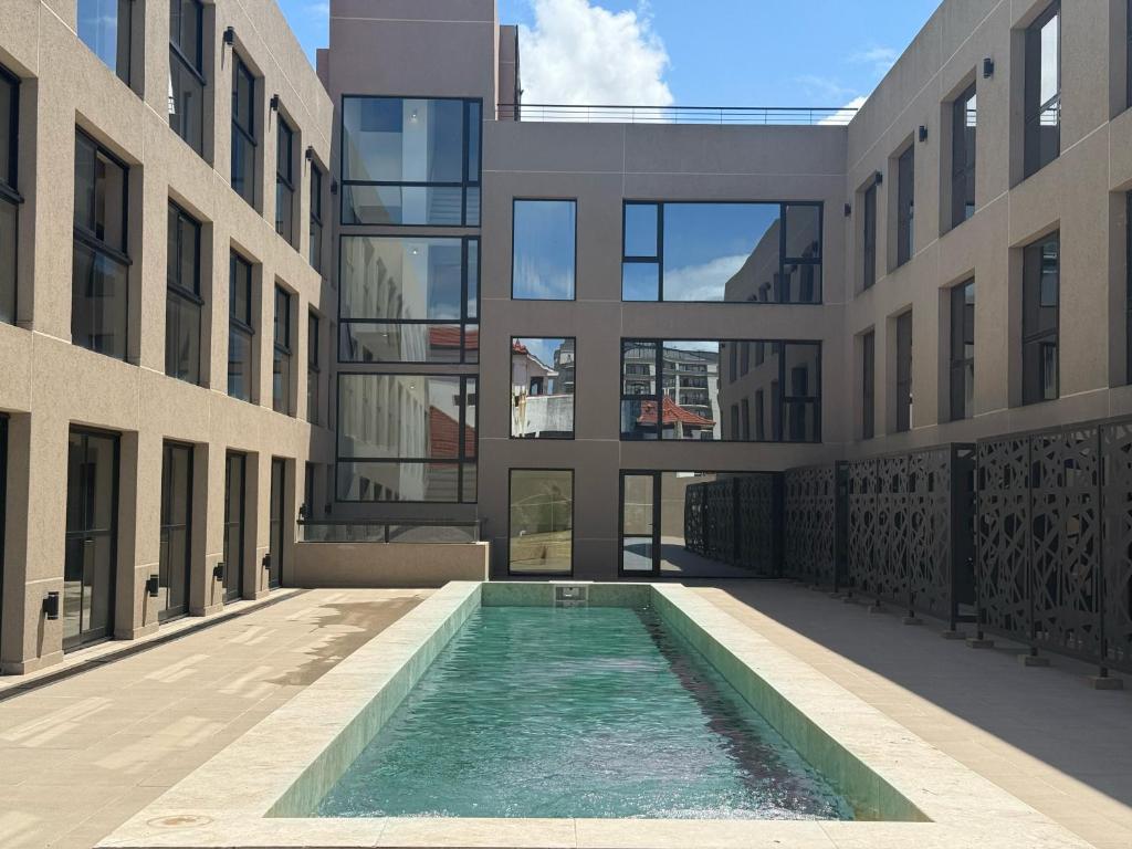 an external view of a building with a swimming pool at Nogales Apartamentos in Mar del Plata