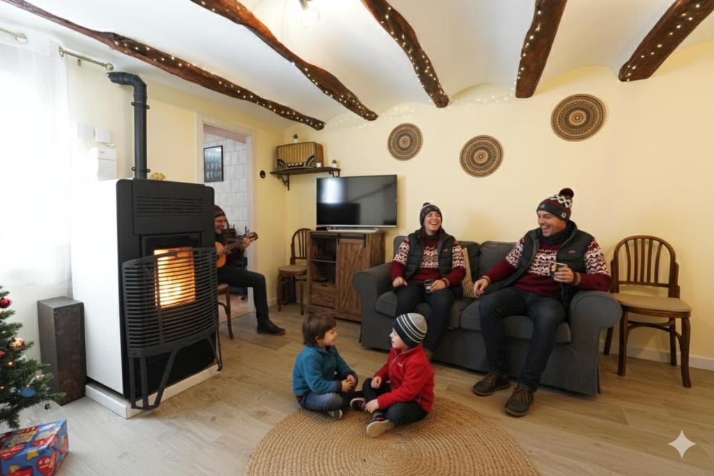 a group of people sitting in a living room with a fireplace at Casa Ladislada in Cella