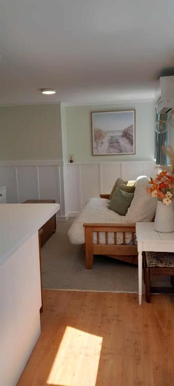 a living room with a bed and a table at Green on Queen in Richmond