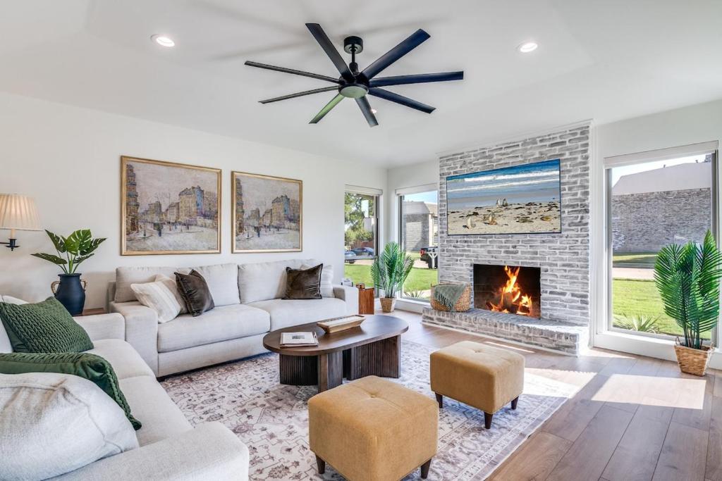 a living room with a couch and a fireplace at The Goph Getaway 4B 2B Duplex KING Pet Friendly in Richardson