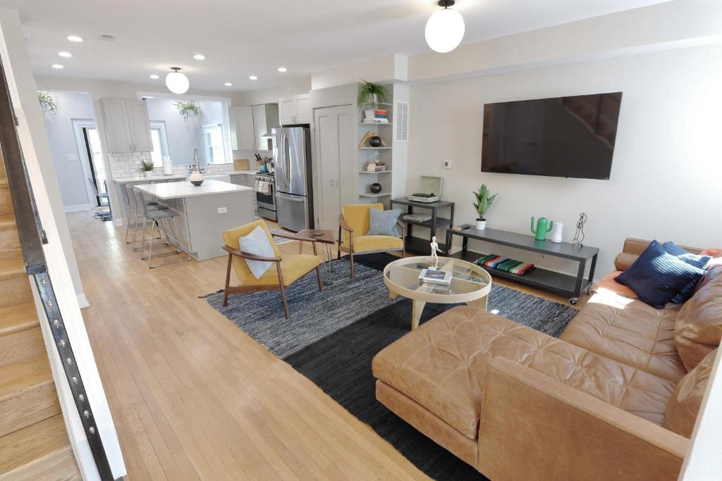 a living room and kitchen with a couch and a table at Stadium Armory Stay in Washington