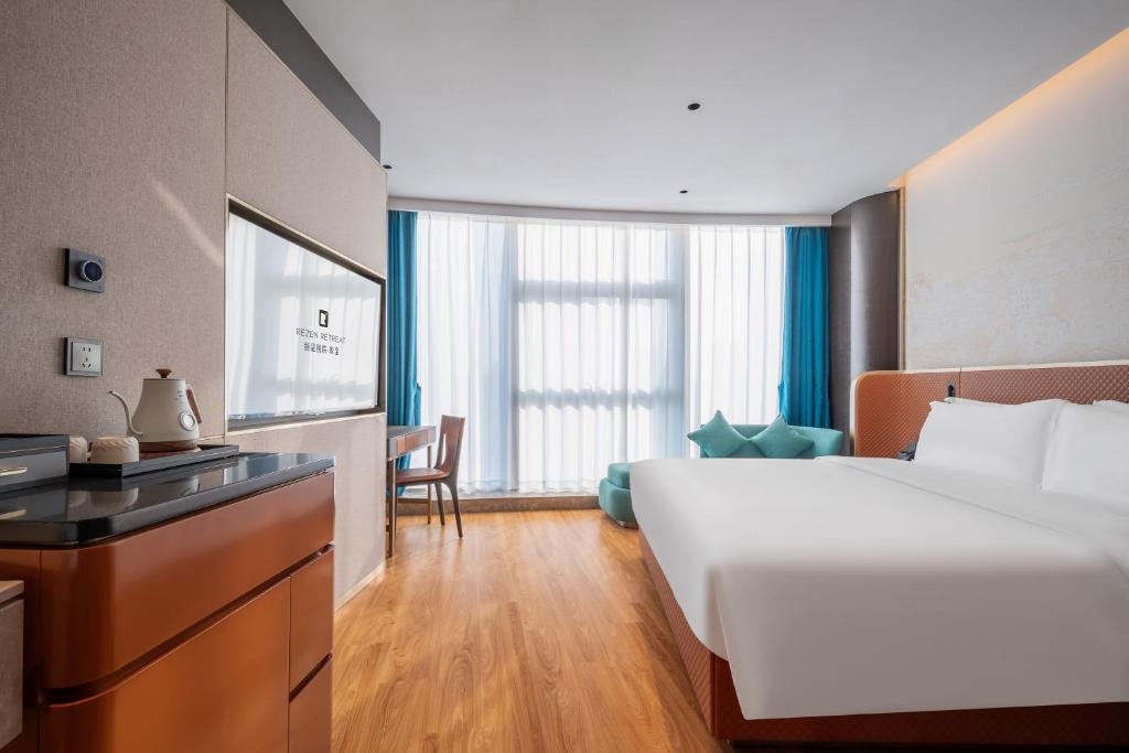 Postel nebo postele na pokoji v ubytování Licheng Bieyuan Meibao Hotel