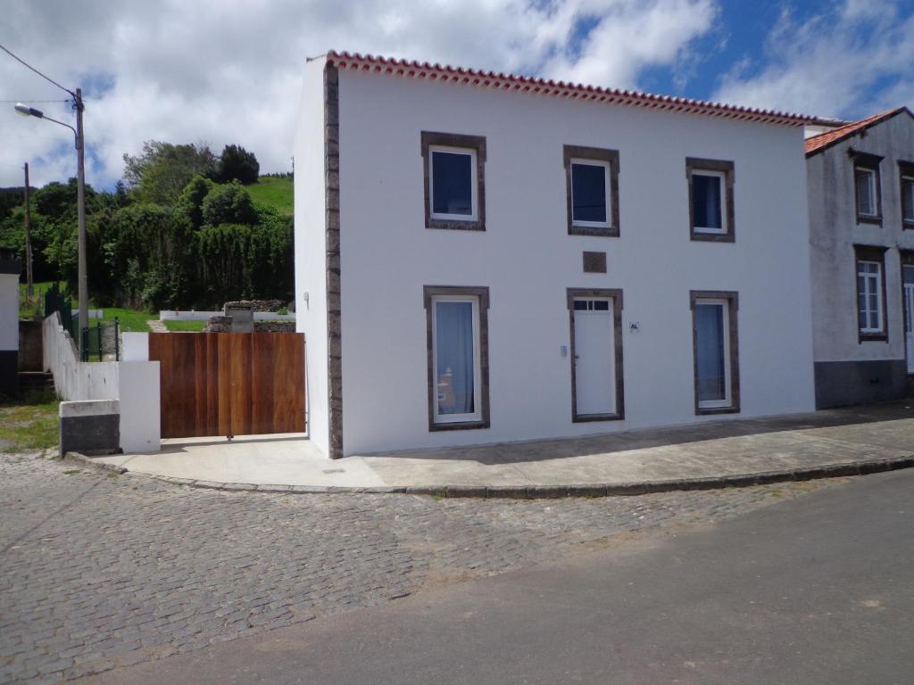a white house on the side of a street at Casa do Simão in Nordeste