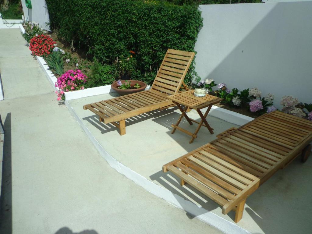 a bench and a table and a chair on a patio at Casa do Simão in Nordeste