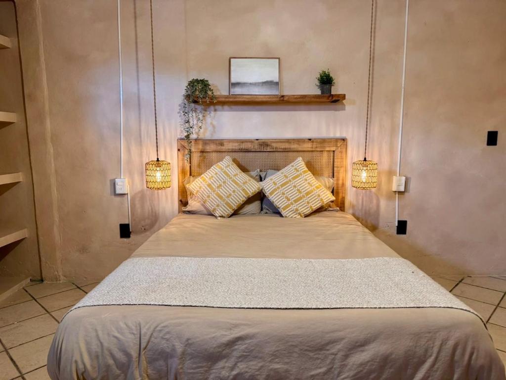 オアハカにあるCasa Resplandorのベッドルーム1室(ベッド1台、ライト2つ付)