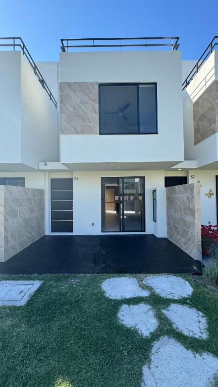 a large white house with a grass yard at House Alto 58 Xochitepec Morelos in Xochitepec