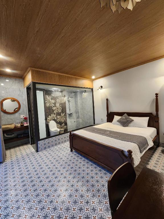a bedroom with a large bed and a large window at Villa Full House in Vũ Lâm