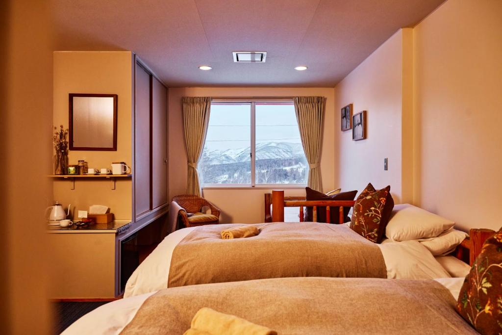 Postel nebo postele na pokoji v ubytování Canopy Lodge - Boutique Lodge at Hakuba Cortina