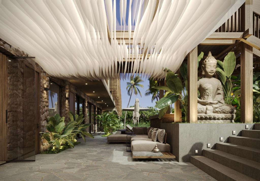 een lobby met een groot wit plafond en een standbeeld bij Awwa Boutique Hotel in Canggu