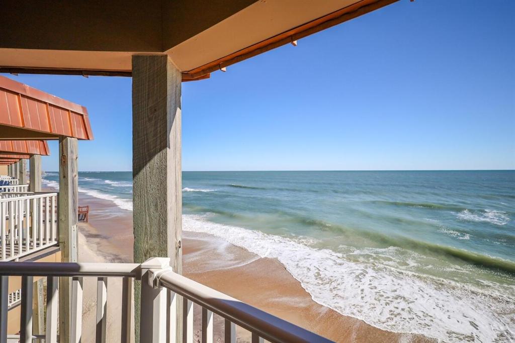 a view of the ocean from a balcony of a beach at Coast is Clear- Oceanfront Escape at Topsail Dunes in North Topsail Beach