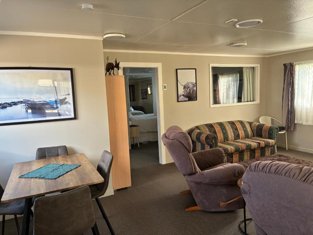 a living room with a couch and a table and chairs at Quiet & Close to Town in Taupo