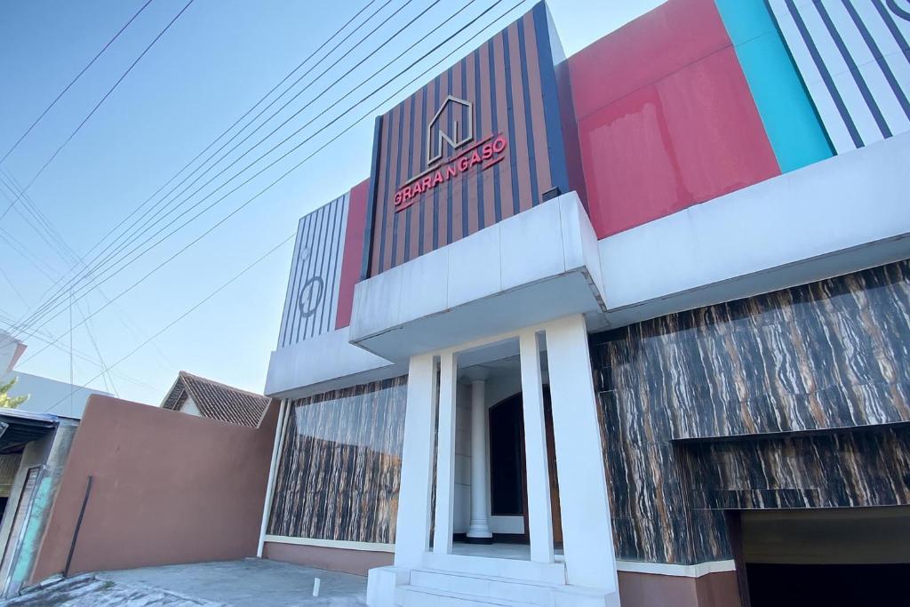 a building with a sign on the side of it at Hotel O near Maguwoharjo Stadium formerly Graha Ngaso in Seturan