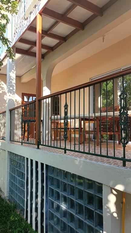 a balcony of a house with a swimming pool at Skyline View Garden Apartment in Bel Ombre
