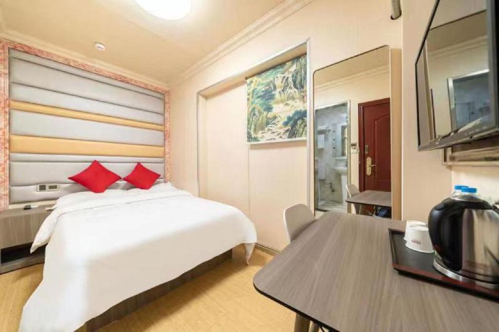 Postel nebo postele na pokoji v ubytování Shanghai Yujia Hotel