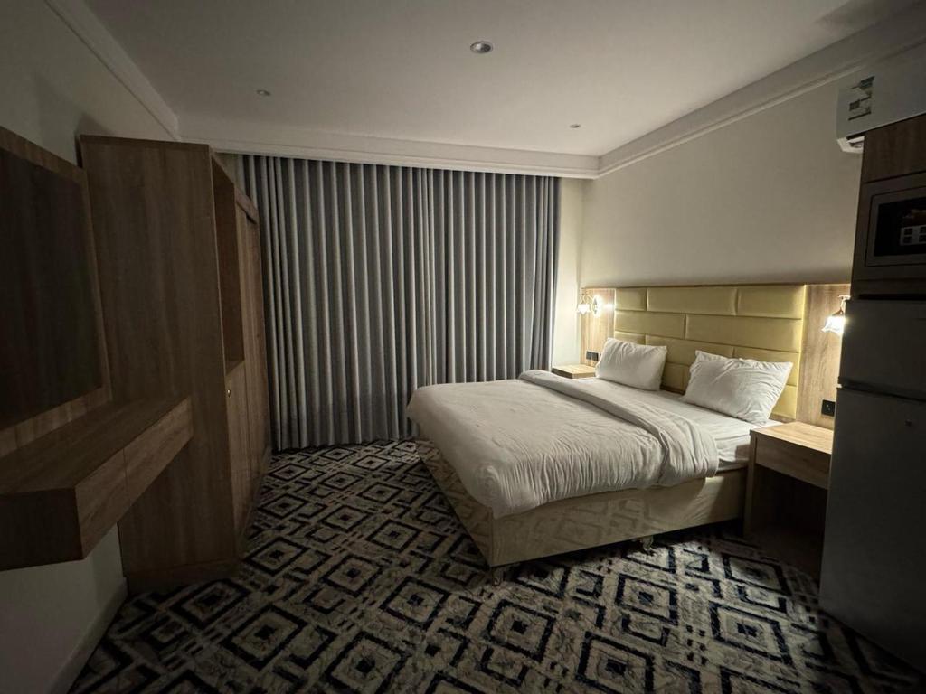a hotel room with a bed in a room at Al Madinah Hotel in Al Madinah