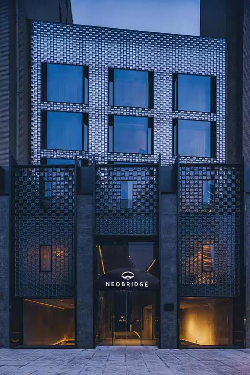 a building with a sign on the front of it at Neobridge Hotel in Shanghai
