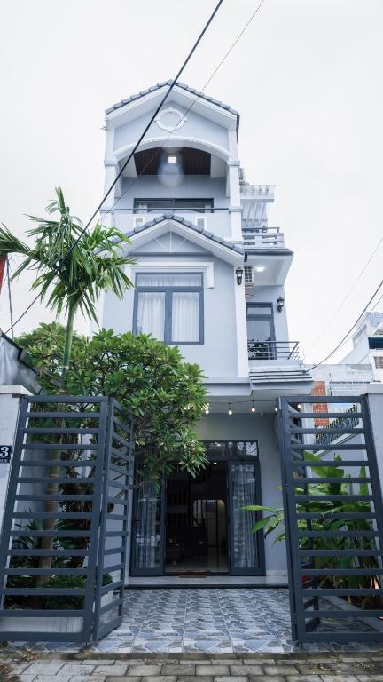 a white building with a staircase in front of it at Son Tra homestay in Danang