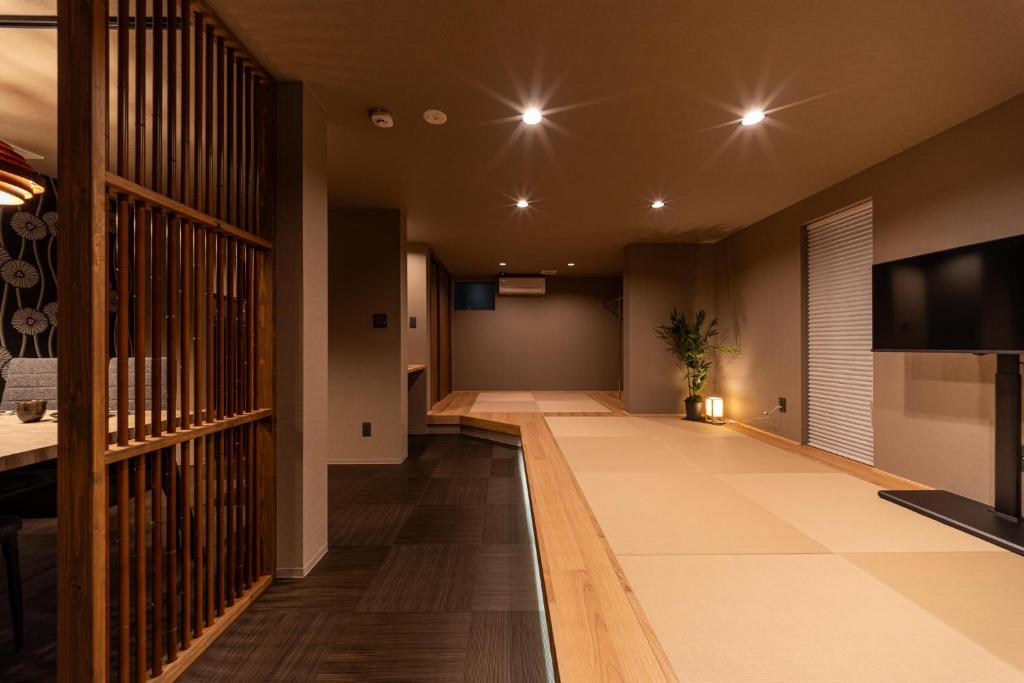 an empty hallway of a building with a flat screen tv at おやど紀伊国屋宝町 in Nagasaki