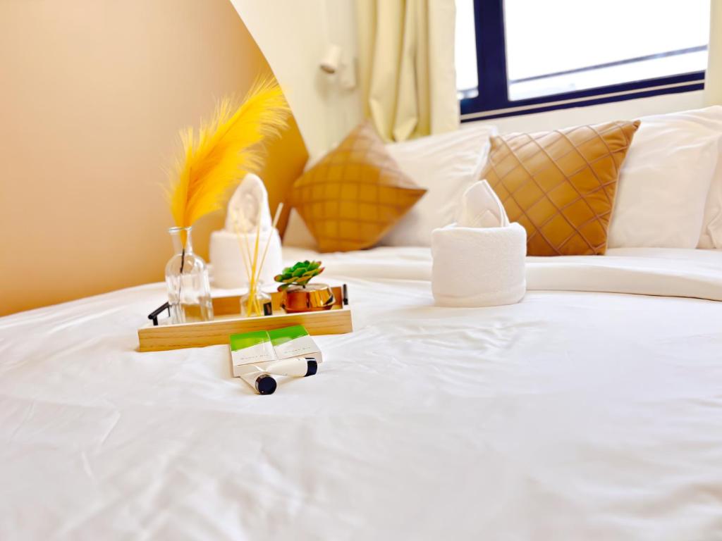 a hotel room with a white bed with a toy on it at Casita Aroha SHORE 2 B02-19114 in Sampong