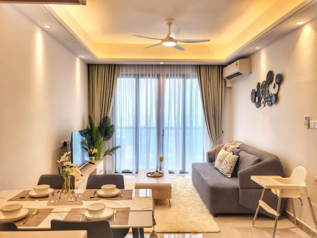 a living room with a couch and a table at R&F Princess Cove 2BR Sea View Family Friendly in Johor Bahru