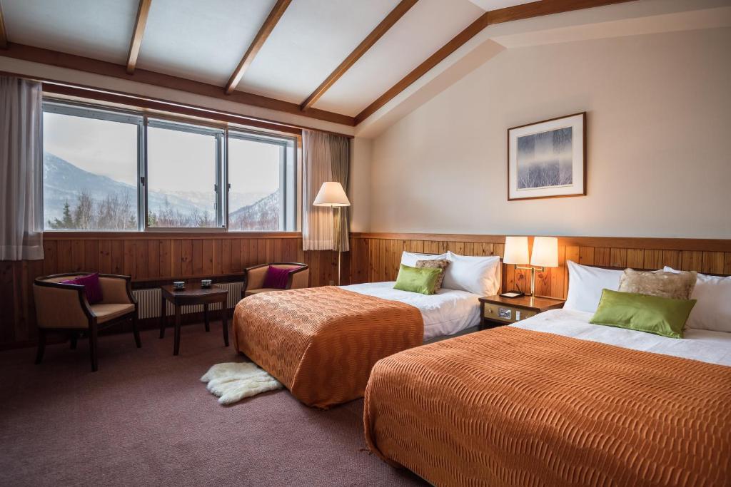 Postel nebo postele na pokoji v ubytování Okushiga Kogen Hotel