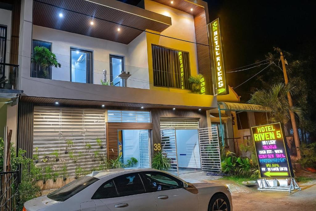 a white car parked in front of a house at River Hotel 5 in Long Xuyên